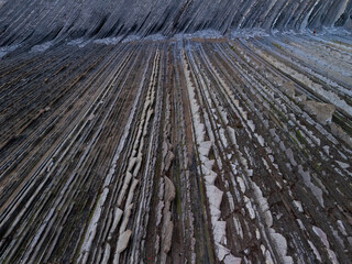 Obraz premium Aerial view of the Sakoneta Flysch at low tide on the Cantabrian Coast in Deva in the province of Gipuzkoa in the autonomous community of the Basque Country. Spain. Europe.