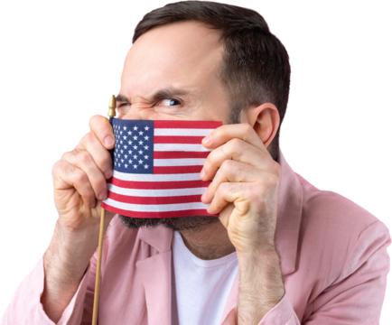 Portrait of a satisfied young man with a beard with an American flag on a red studio background. Great US patriot and defender of freedom.