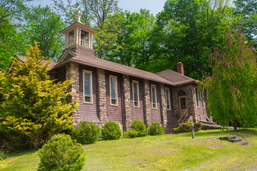 the side exterior and bell tower of a stone church in tobyhanna pennsylvania