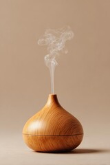 Wooden essential oil diffuser releasing steam on a plain background