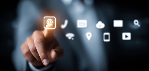 Modern businessperson interacting with digital icons representing technology communication and online connectivity in a high-tech environment