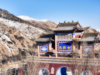 Ancient Temple Nestled Under Snow-Capped Mountains