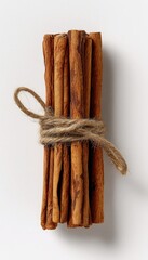 Top-Down View of Cinnamon Sticks Tied with Twine on White Background