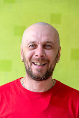 A man poses against a wall, making various grimaces