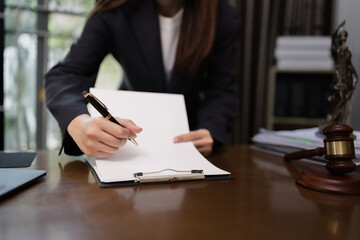 Lawyer Businesswoman Working with Documents and Signing Contract at Office Desk, Hammer on Wood table, Judge's Gavel, Law, Justice Symbol,