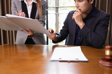 Two Lawyer with Document Paper and Hammer on Wood table,  Judge's Gavel, Law, Justice Symbol, Agreement and Partnership Concept,