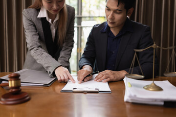 Two Lawyer with Document Paper and Hammer on Wood table,  Judge's Gavel, Law, Justice Symbol, Agreement and Partnership Concept,