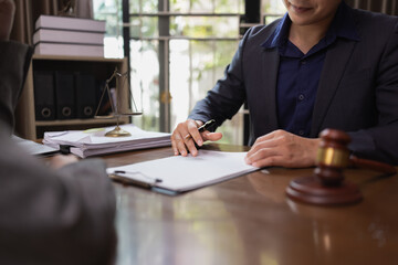 Two Lawyer with Document Paper and Hammer on Wood table,  Judge's Gavel, Law, Justice Symbol, Agreement and Partnership Concept,