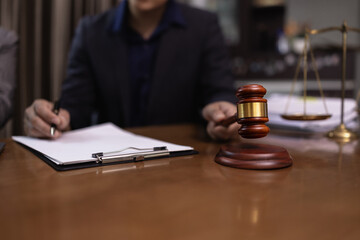 Lawyer Holding Hammer with Document Paper on Wood table,  Law, Justice Symbol,
