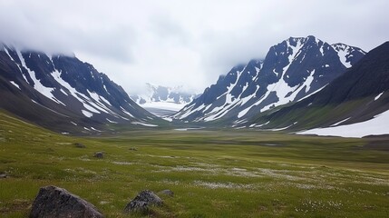A serene valley nestled between snow-capped mountains, lush green meadows dotted with rocks under a cloudy sky