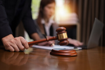 Lawyer Holding Hammer with Document Paper on Wood table,  Law, Justice Symbol,