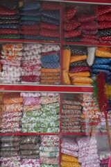 A display of various colorful textile products, clothing materials
