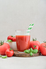 Tomato juice in a glass and fresh tomatoes