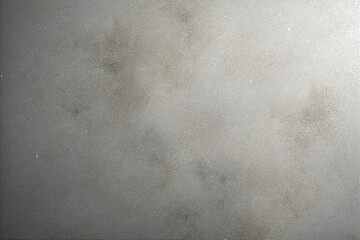 Abstract gray metallic texture background with a grainy surface and light reflection.