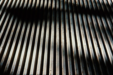Concrete wall with vertical lines cinematic pattern with dramatic shadows. Good to use in projects...