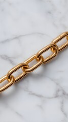 "Luxurious Gold Chain on Elegant Marble Surface"