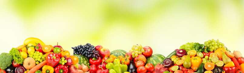 Photo fresh various fruits, vegetables and berries on green background.
