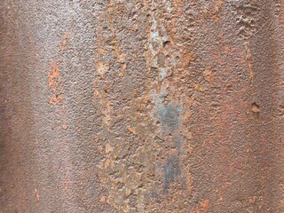 A close-up of severely rusted and corroded metal, displaying a rich texture of pitted surfaces,...