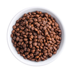 Brown round cereal pieces in a white bowl on a solid background for breakfast or snack ideas