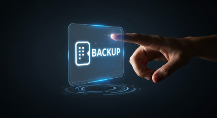Data Backup Touch: A close-up shot of a hand interacts with a glowing virtual button labeled Backup, highlighting the critical process of safeguarding digital information against loss.