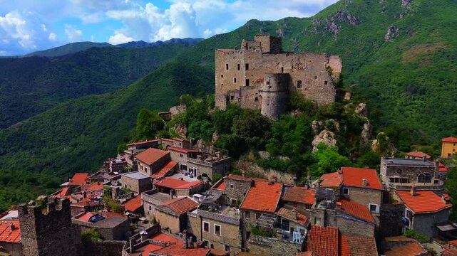 Aerial view of the ruins of an ancient castle, a medieval village on a hill near the Neva River valley and built for defensive purposes, history. Castelvecchio di Rocca Barbena Savona Italy 01.09.2025