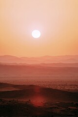 Summer desert landscape glowing under a vibrant sunset with red sun Generative AI