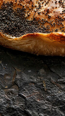 Vertical close-up of Haláš, highlighting golden-brown crust with poppy seeds or raisins