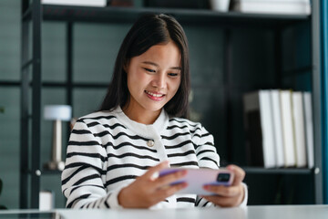 Woman concentration focus online gaming with smartphone