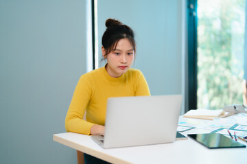 Portrait of Young creative startup woman at workplace