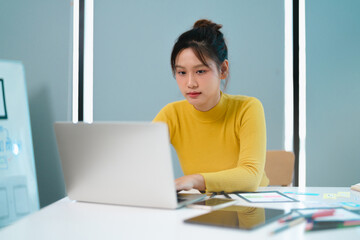 Portrait of Young creative startup woman at workplace