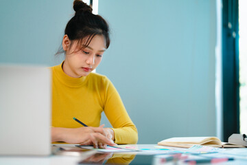 Portrait of Young creative startup woman at workplace