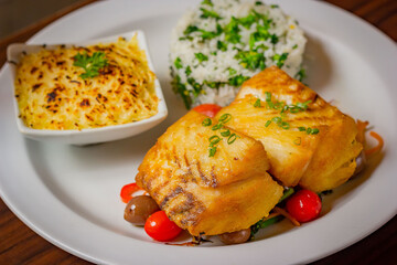 Grilled sea bass served with creamy mashed potato casserole and broccoli rice