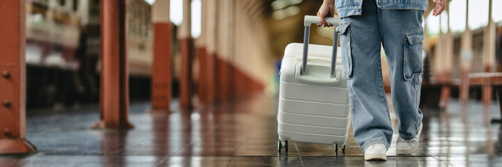 Traveler woman with suitcase at train station for trip