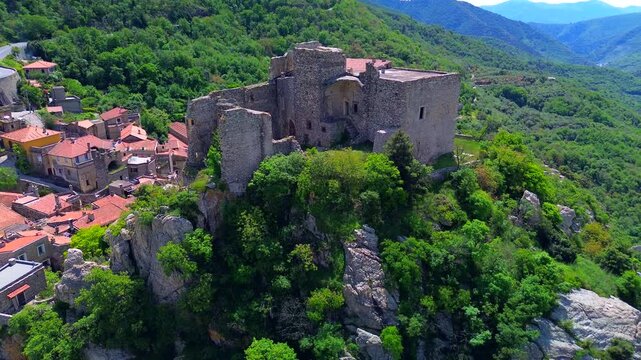 Aerial view of the ruins of an ancient castle, a medieval village on a hill near the Neva River valley and built for defensive purposes, history. Castelvecchio di Rocca Barbena Savona Italy 22.09.2025