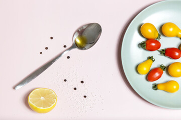 Summer salad ingredients - Freshly harvested cherry tomatoes, spoon of vinegar and olive oil, salt and pepper
