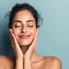 A woman with closed eyes touches her smooth skin and smiles
