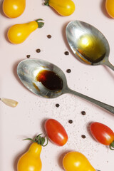Summer salad ingredients - Freshly harvested cherry tomatoes, spoon of vinegar and olive oil, salt and pepper
