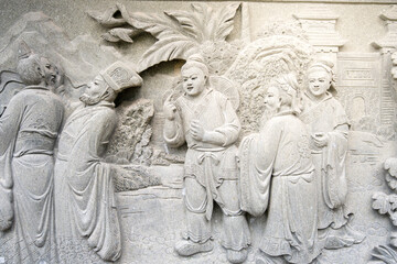 Obraz premium Ancient Stone Carving Depicting a Scene with Multiple Figures