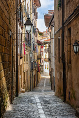 Narrow cobbled streets with flowered balconies and old buildings in the tourist town of Hondarribia, Guipuzcoa.