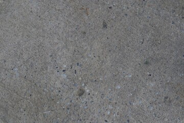 Subtle textured background with mottled grey concrete surface and embedded aggregate fragments
