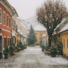 Fototapeta premium Charming winter scene with snow falling on historic European town square and buildings