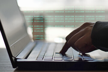 Hacker or Programmer Hands Typing with Green Binary Stream Overlaid, Concept of Digital Security - Person Typing on Laptop Keyboard with Dynamic Binary Code Overlay, Representing Data Processing