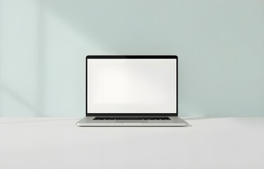 Fototapeta premium Silver laptop with blank screen on a table, perfect for showcasing your business or technology designs