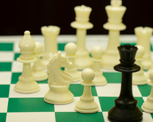 Close up the queen chess piece standing with chessboard on dark background. Leader, influencer, lonely, commander, strong, and business strategy concept.
