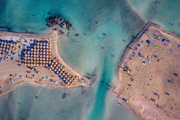 Aerial view of beautiful tropical Elafonissi Beach with pink sand. View of a nice tropical Elafonissi beach from the air. Beautiful sky, sea, resort. Elafonissi beach, Crete, Greece.