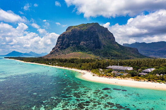 Aerial view of Le morne Brabant in Mauriutius. Tropical crystal ocean with Le Morne mountain and luxury beach in Mauritius. Le Morne beach with palm trees, white sand and luxury resorts, Mauritius. - Powered by Adobe