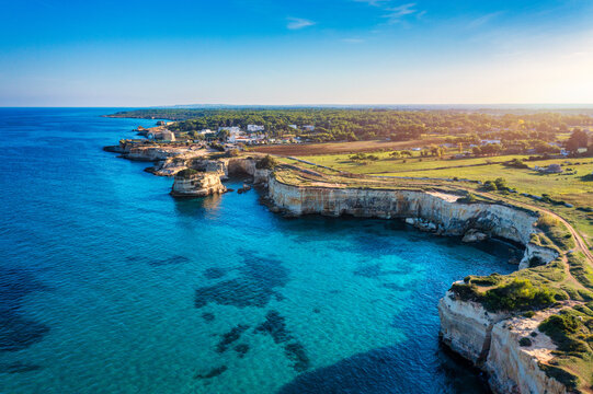 Stunning seascape with cliffs rocky arch and stacks (Faraglioni) at Torre Sant Andrea, Salento coast, Puglia region, Italy. Beautiful cliffs and sea stacks of Sant'Andrea, Salento, Apulia, Italy
