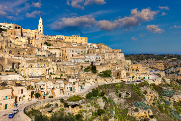 Obraz premium Panoramic view of the ancient town of Matera (Sassi di Matera) in a beautiful autumn day, Basilicata, southern Italy. Stunning view of the village of Matera. Matera is a city on a rocky outcrop.