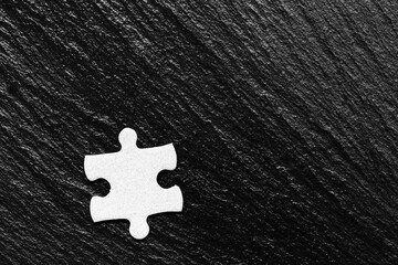 White jigsaw puzzle pieces. Fill in pieces of the jigsaw puzzle. Complete the jigsaw puzzle with the missing pieces. Fragment of a folded white jigsaw puzzle.