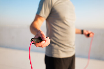 Experience a refreshing jump rope workout at sunrise on a rooftop, surrounded by a beautiful, clear...